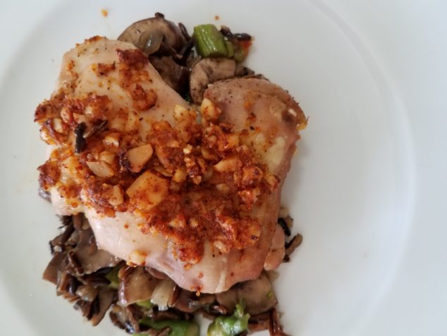 Plated with wild brown rice mixed with sautéed onions, asparagus, and mushrooms with a splash of tamari sauce.